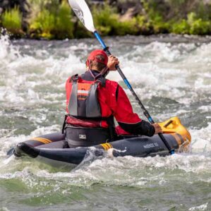 Kayaker paddling the river on the McKenzie inflatable kayak.