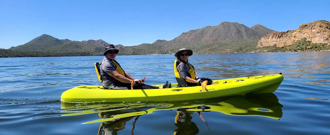A couple enjoying a Tandem Kayaking Tour at Saguaro Lake just outside Scottsdale and Mesa, Arizona. Come join Riverbound on one of our Phoenix area tours.