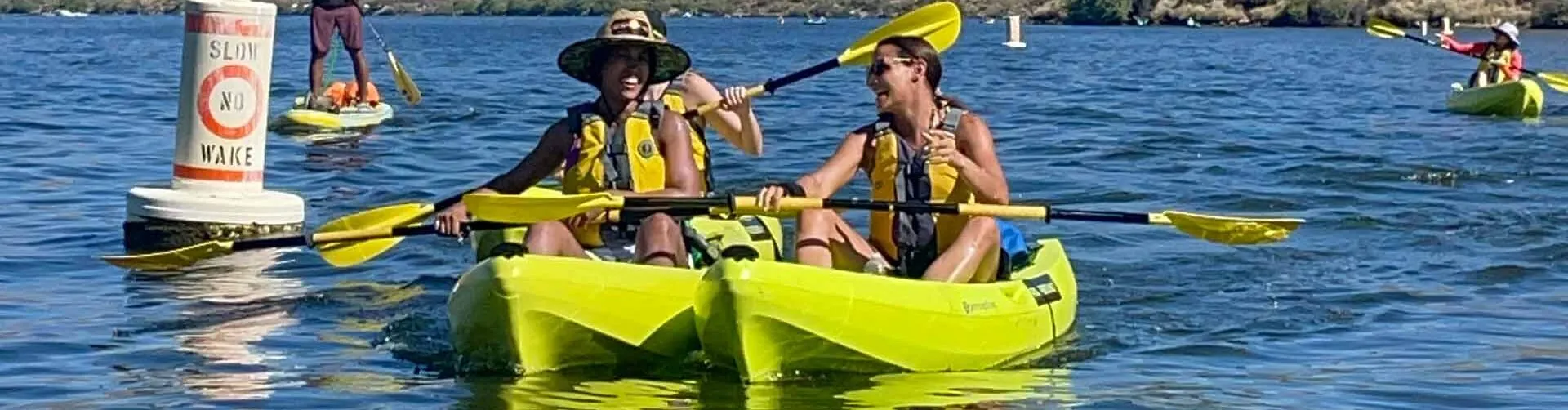 Two people kayaking on a sunny day on Saguaro lake. Riverbound Sports Paddle Company