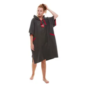 Woman modeling gray Red Paddle Co hooded quick dry changing robe with red accents front view. Available at Riverbound Sports in Tempe, Arizona.