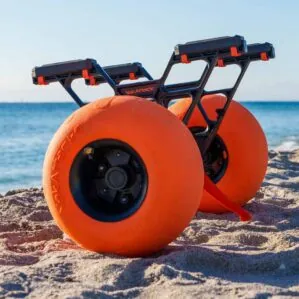 YakAttack Townstow Kayak Cart with orange pneumatic sand tires on the beach. Available at Riverbound Sports in Tempe, Arizona.