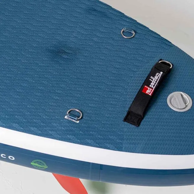 Close-up of blue textured paddleboard deck with accessories.