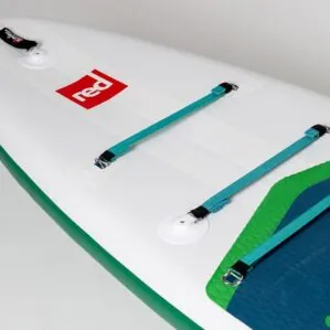 White paddleboard with teal straps and red logo detail.
