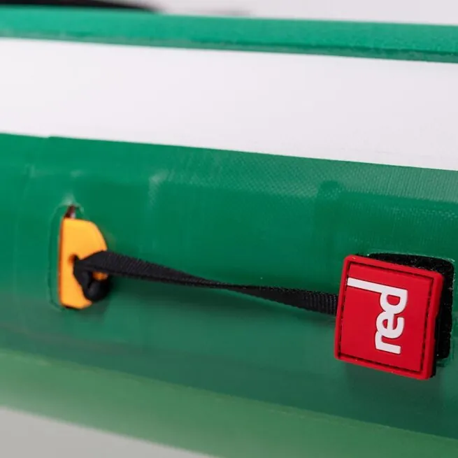 Close-up of green bag with red logo and yellow clip