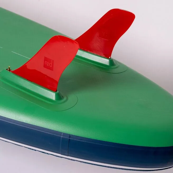 Green paddleboard with red fins on white background.