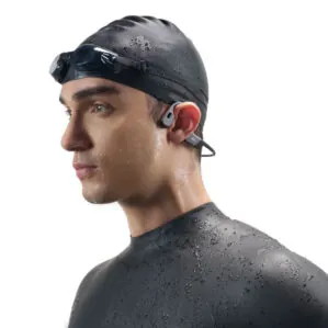 Swimmer wearing goggles and earbuds, wet after swim