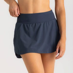 Woman in Free Fly Breeze blue dus II skorts. Available at Riverbound Sports in Tempe, Arizona.