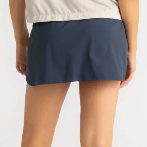 Woman in Free Fly Breeze blue dus II skorts. Available at Riverbound Sports in Tempe, Arizona.