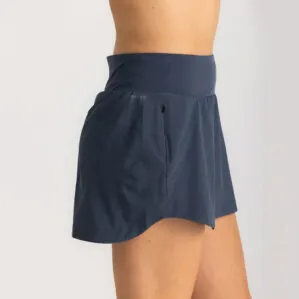 Woman in Free Fly Breeze blue dus II skorts. Available at Riverbound Sports in Tempe, Arizona.