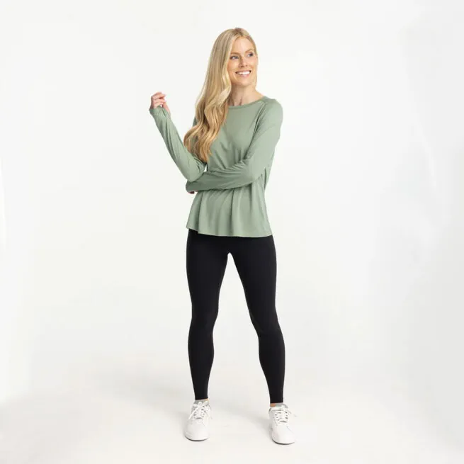 A women in a Free Fly lightweight bamboo long sleeve in palm green color. Available at Riverbound Sports in Tempe, Arizona.