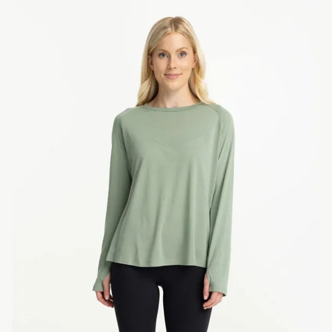 A women in a Free Fly lightweight bamboo long sleeve in palm green color front view. Available at Riverbound Sports in Tempe, Arizona.