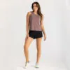 Woman in Free Fly taupe tank top and Breeze black shorts. Available at Riverbound Sports in Tempe, Arizona.