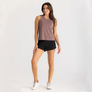 Woman in Free Fly taupe tank top and Breeze black shorts. Available at Riverbound Sports in Tempe, Arizona.