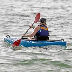 Person kayaking in choppy water