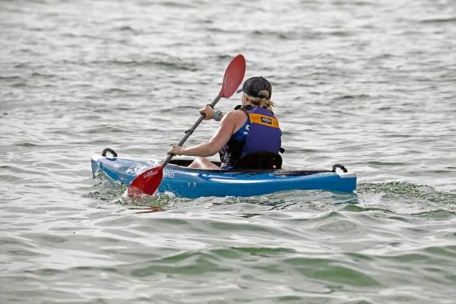 Person kayaking in choppy water