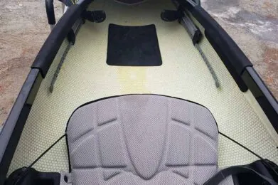 Interior of a kayak showing seat and footrest.