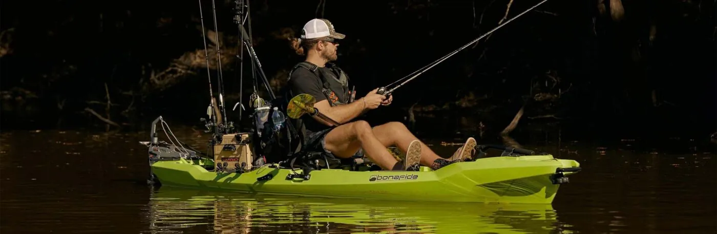 Man fishing from a Bonafide RVR119 green kayak.