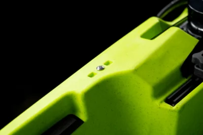 Close-up of bright green scooter deck with water droplet.