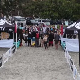 Beach sports event with participants and branded tents