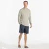 Man in beige hoodie and blue dusk II Free Fly Breeze 8" shorts at Riverbound Sports in Tempe, Arizona.