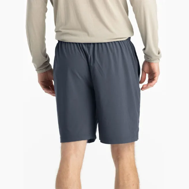 Man in beige hoodie and blue dusk II Free Fly Breeze 8" shorts at Riverbound Sports in Tempe, Arizona.