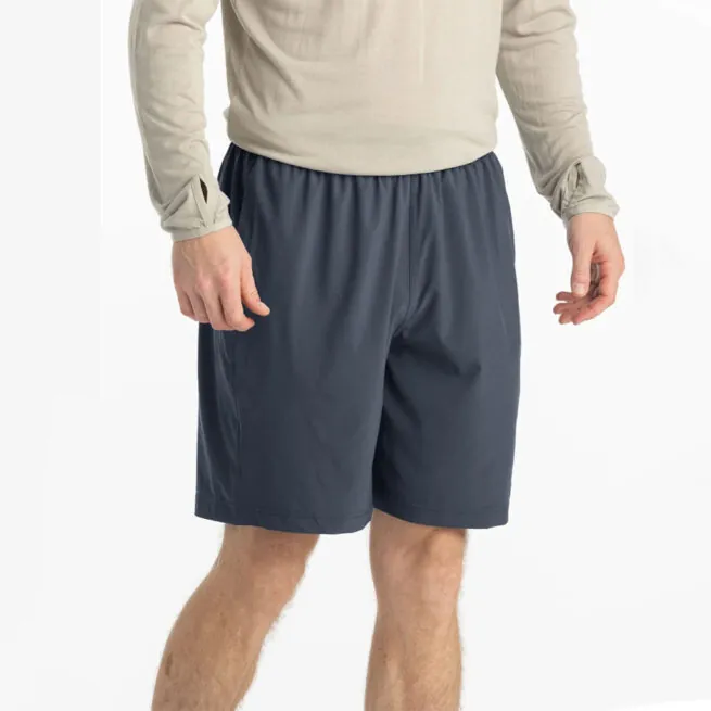 Man in beige hoodie and blue dusk II Free Fly Breeze 8" shorts at Riverbound Sports in Tempe, Arizona.