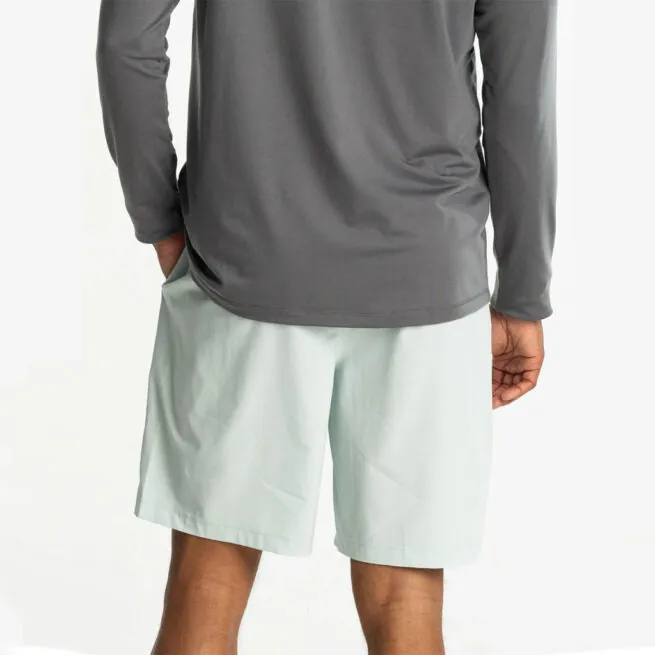 Man in grey hoodie and surf spry color Free Fly Breeze 8" shorts at Riverbound Sports in Tempe, Arizona.