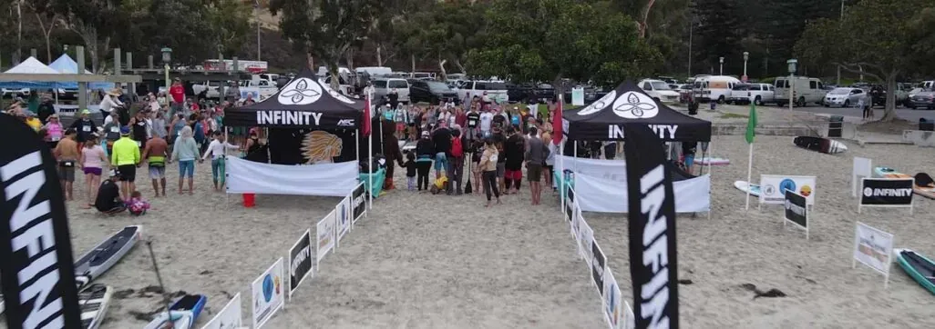 Beach sports event with participants and branded tents