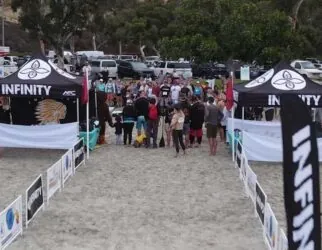 Beach sports event with participants and branded tents